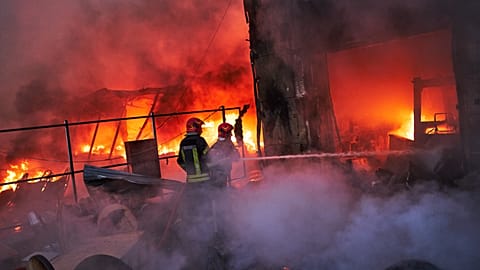 Firefighters try to extinguish a fire following a Russian missile attack in Kyiv, 8 September, 2026
