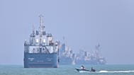 FILE: A small motorboat passes anchored vessels in the Strait of Hormuz off Bandar Abbas, Iran, 11 June 2026