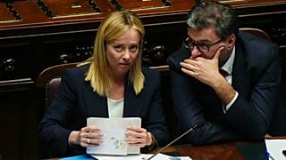 Italian Premier Giorgia Meloni, left, talks with Minister of Economy and Finance Giancarlo Giorgetti ahead of a confidence vote for her Cabinet, Tuesday, Oct. 25, 2022.