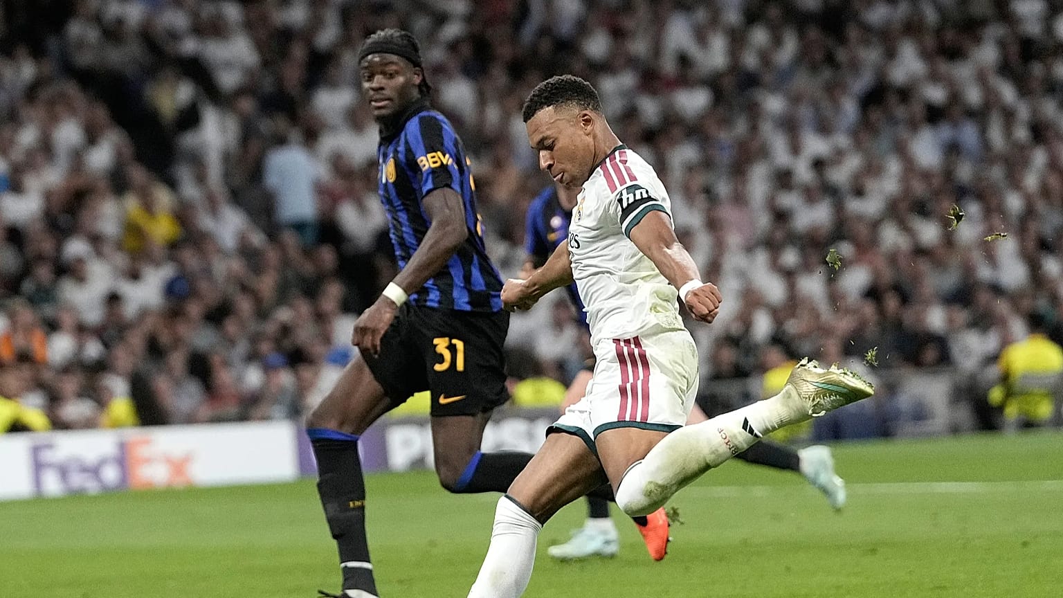 Real Madrid's Kylian Mbappe fights for the ball against Inter Milan's Yann Bisseck 