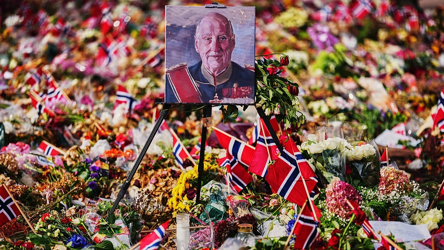 A painting of Norway's late King Harald stands in floral tributes at the Palace Square at the eve of his funeral, in Oslo, Norway, Tuesday, Sept. 8, 2026