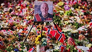 A painting of Norway's late King Harald stands in floral tributes at the Palace Square at the eve of his funeral, in Oslo, Norway, Tuesday, Sept. 8, 2026
