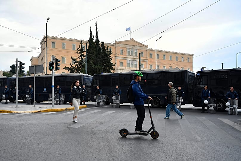 A man on a scooter in front of Parliament in Athens, 17 November, 2022