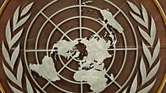 FILE: The United Nations logo is seen at the General Assembly hall at UN headquarters, 21 September 2021