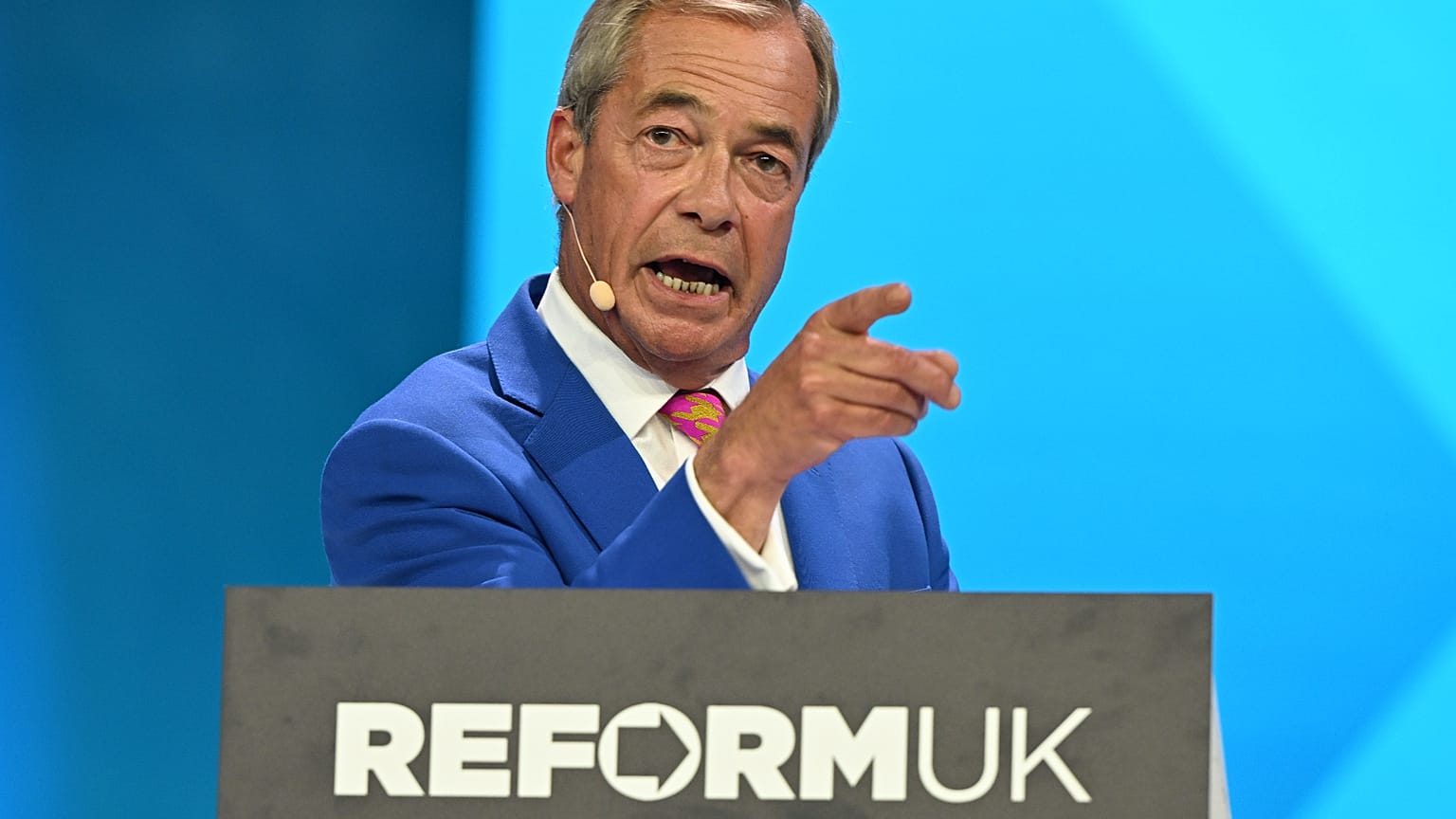 Reform Party Leader Nigel Farage points as he speaks during the Reform party's annual conference at the National Exhibition Centre in Birmingham, England, Friday, 4 Sept. 2026