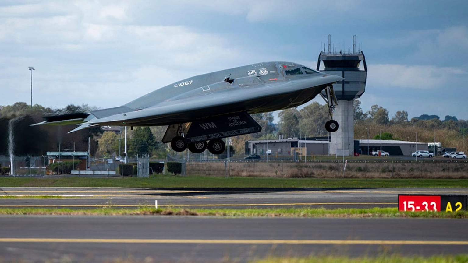 A B-2 bomber and two F-22 fighters