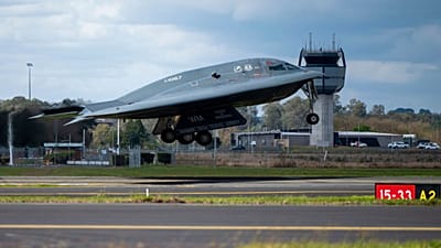 A B-2 bomber and two F-22 fighters