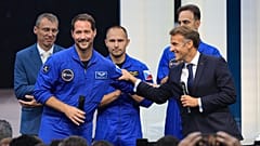 French President Emmanuel Macron clasps arms with French European Space Agency astronaut Thomas Pesquet at the International Space Summit, Grand Palais, Paris, 9 September.