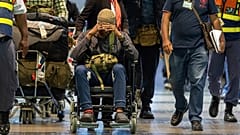 South African men who were allegedly tricked into fighting for Russia in the war in Ukraine arrive at an international airport in South Africa