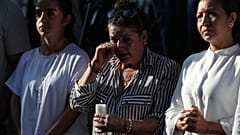 Relatives and friends of earthquake victims attend a vigil marking the one-month anniversary of the earthquake in Cali,