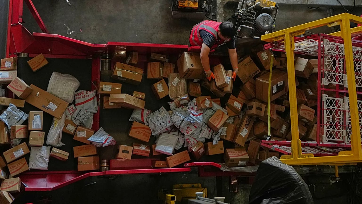 A worker sorts parcels for e-commerce platform JD.com at a distribution centre in Beijing.