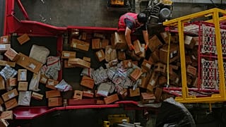 A worker sorts parcels for e-commerce platform JD.com at a distribution centre in Beijing.