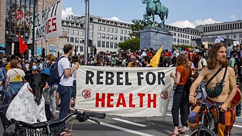 People, most of them wearing protective face masks, gather during a healthcare workers' protest in downtown Brussels, Saturday, May 29, 2021. 