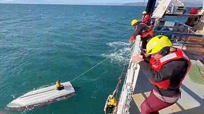 This image taken from video provided by Carlos Alexis Escartin shows a teenager being rescued by a fishing vessel
