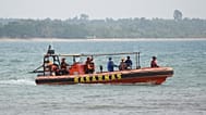 Rescuers ride on a rubber boat during the search for the journalists who went missing while covering the eruption of Mount Anak Krakatau, in Pandeglang, Indonesia.