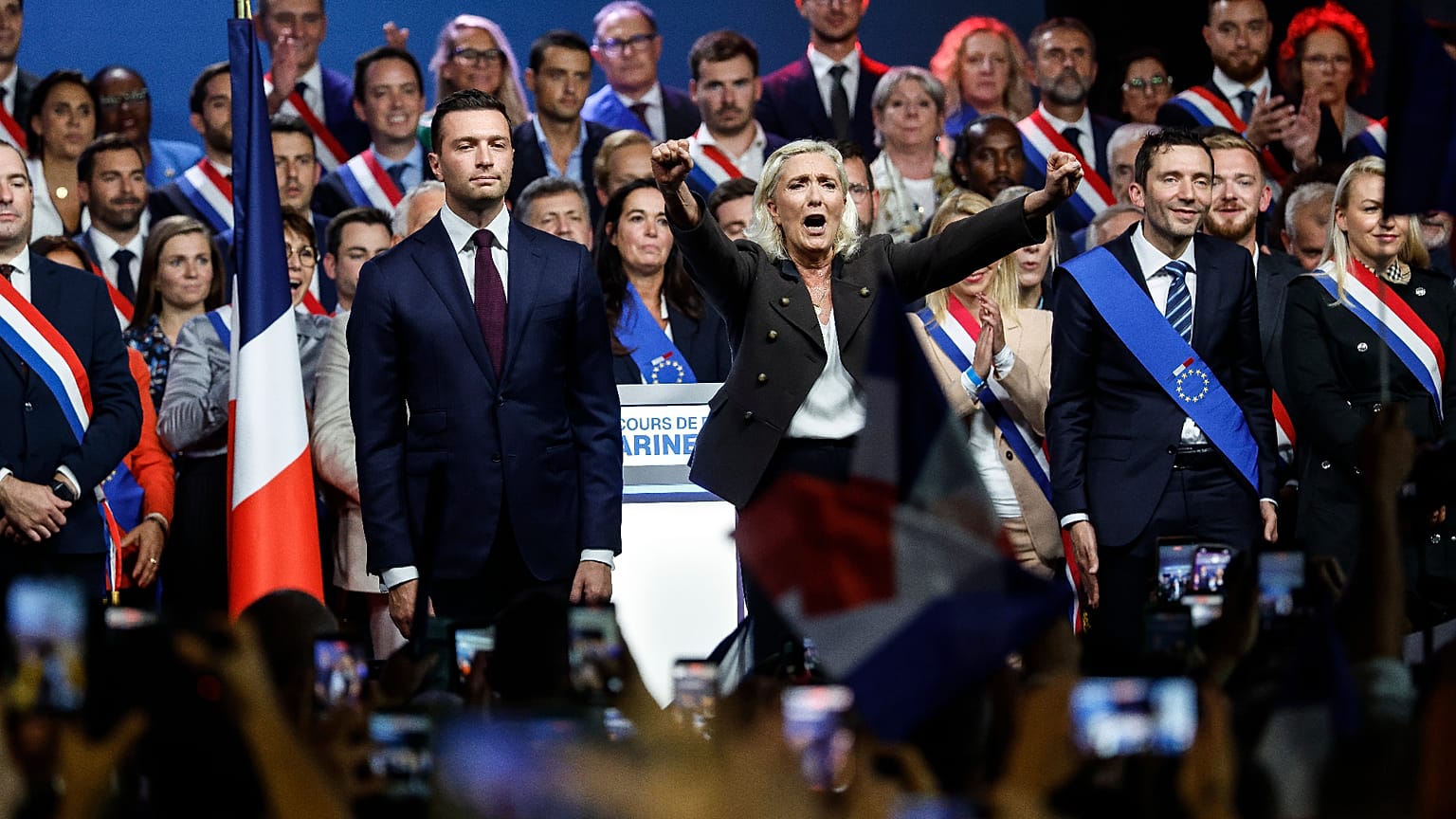 French far-right leader Marine Le Pen greets the crowd at the end of her political meeting in Henin-Beaumont, northern France, 13 September,