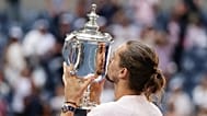 Alexander Zverev, of Germany, goes to kiss the trophy after he won the men's singles final of the U.S. Open tennis championships against Ben Shelton, of the United States