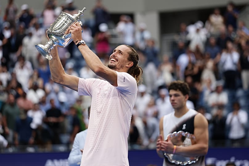 Alexander Zverev, of Germany, left, poses with the trophy after he won the men's singles final of the U.S. Open tennis championships against Ben Shelton, of the United States