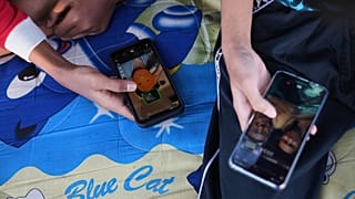 Teenage boys use their mobile phones to browse social media in Jakarta, Indonesia, March 16, 2026.