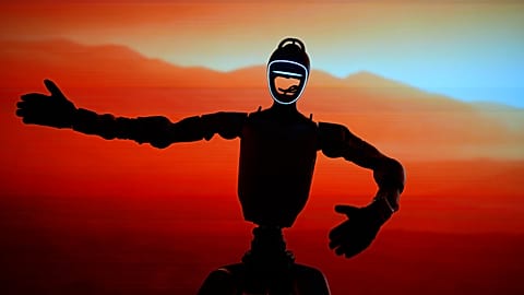 FILE - One of humanoid robots performs at a press conference by GMO, Japanese internet infrastructure company Tuesday, Sept. 8, 2026, in Tokyo. (AP Photo/Eugene Hoshiko)