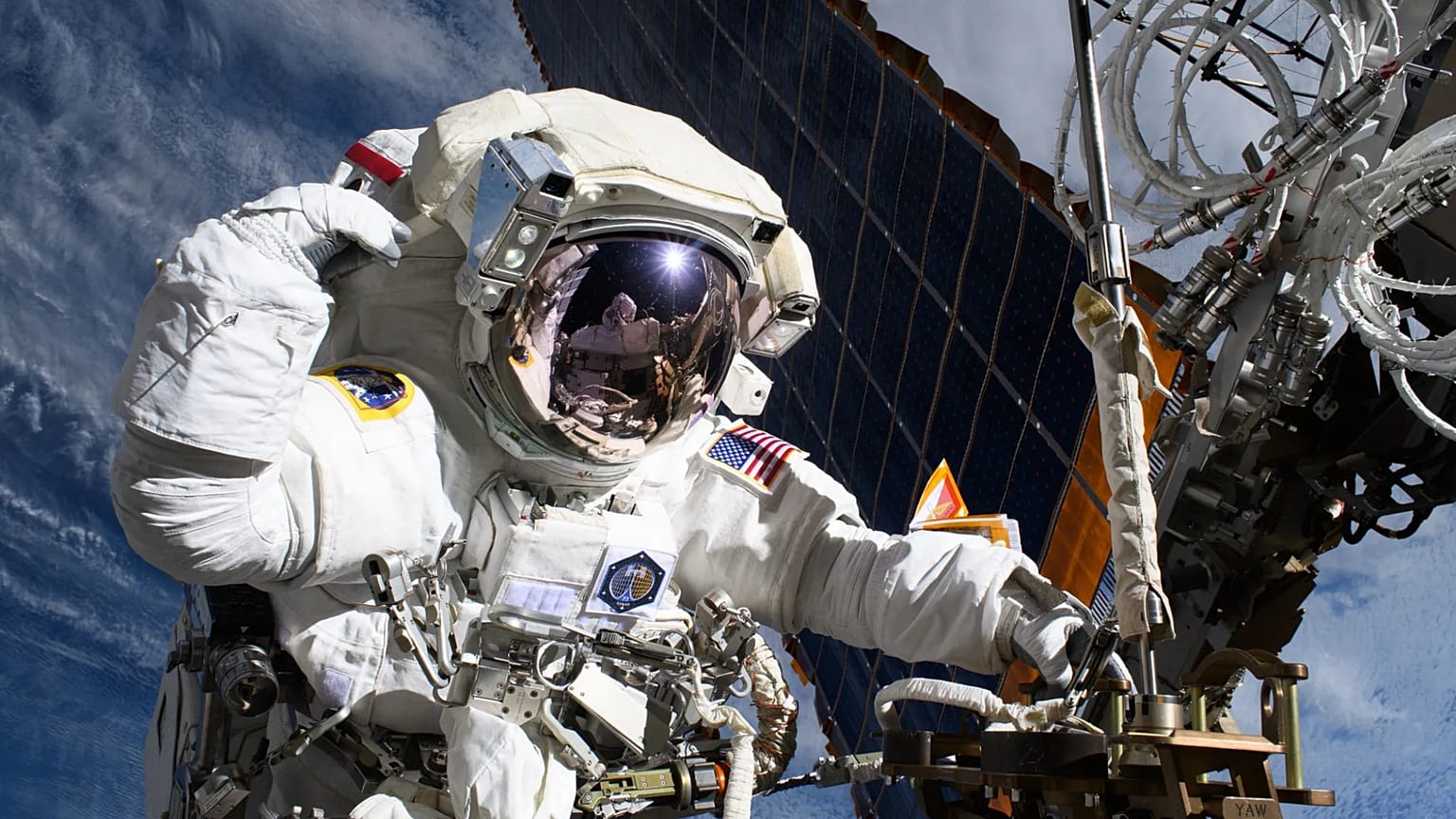 NASA astronaut and Expedition 72 Flight Engineer Anne McClain is pictured near one of the International Space Station’s main solar arrays.