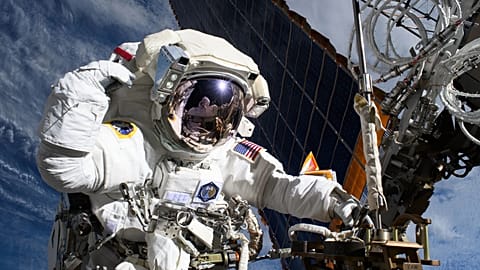 NASA astronaut and Expedition 72 Flight Engineer Anne McClain is pictured near one of the International Space Station’s main solar arrays.