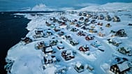 Houses covered in snow are seen on the coast of a sea inlet of Nuuk, Greenland, March 7, 2025.