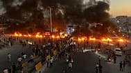 Protesters burn tyres and other debris to block a motorway, as demonstrations against soaring fuel prices spread across Syria.
