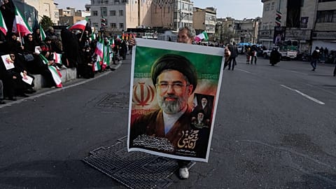 A photo of Mojtaba Khamenei held by a supporter of the Islamic Republic