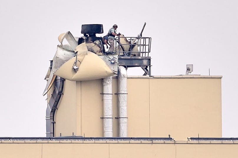 U.S. embassy personnel inspect the damage caused by a bombing in Baghdad in March