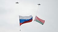 Drones each carry a Russia, left, and Belarus national flag, during the joint Russian-Belarusian military drills at a training ground near Barysaw, Belarus, Sept. 15, 