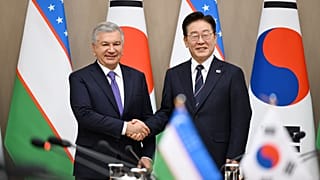 Uzbek President Shavkat Mirziyoyev and South Korean President Lee Jae Myung shake hands during talks in Seoul