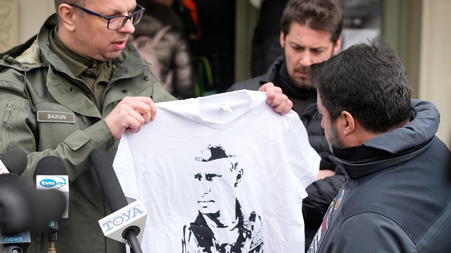 Mayor of Przemysl, Wojciech Bakun holds up a t-shirt with the likeness of Russian President Vladimir Putin as Italy's League Party leader Matteo Salvini March 8, 2022
