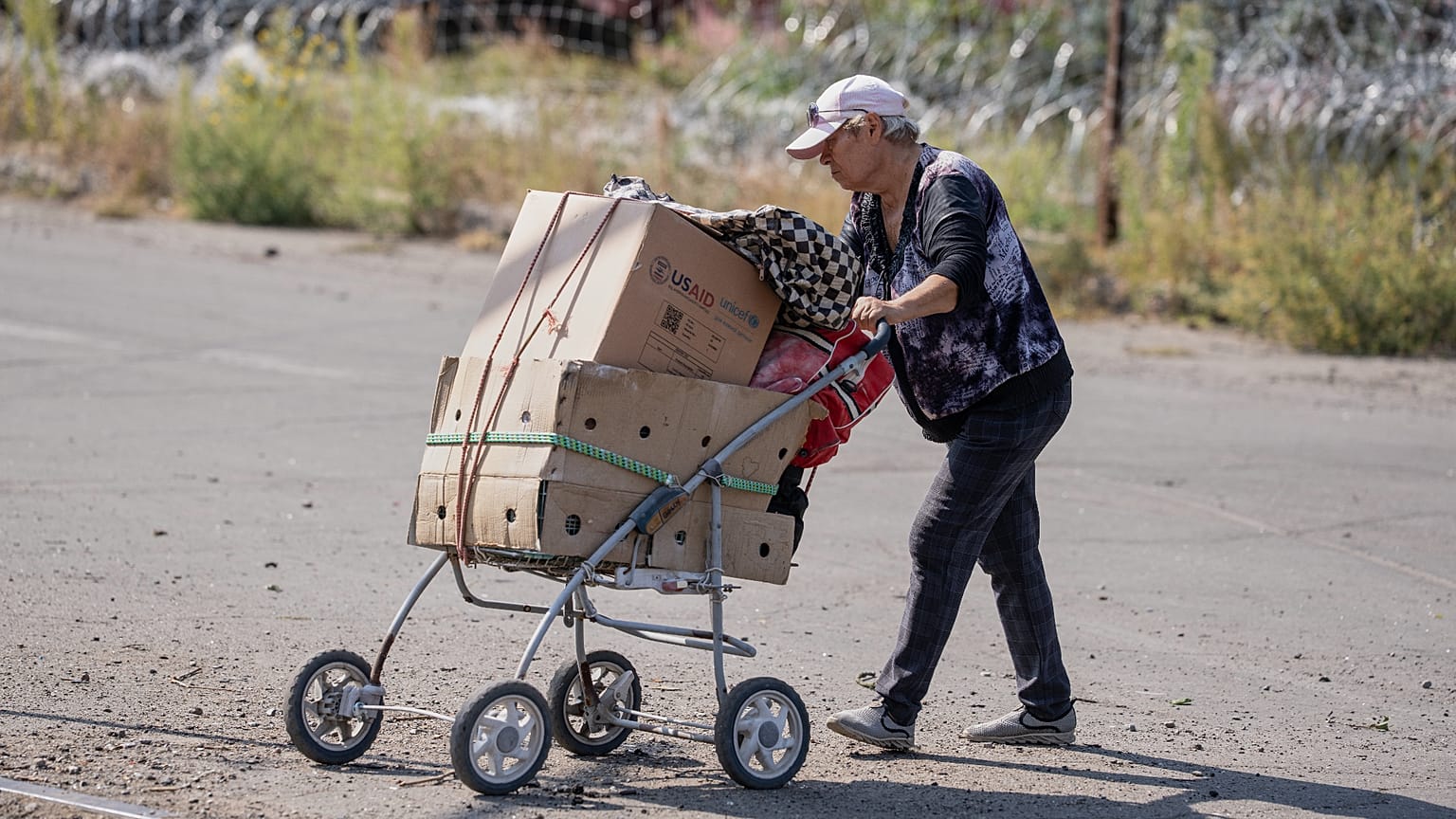 Alocal resident wheels her belongings through the frontline town of Druzhkivka, Donetsk region, Ukraine.  Sept. 12, 2026, 