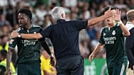 Real Madrid's head coach Jose Mourinho taps hands with Real Madrid's Vinicius Junior, left, and Real Madrid's Arda Guler 