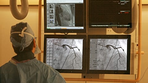 Dr. Harold Dauerman checks monitors during heart surgery in a catheterisation laboratory in Burlington, in the US state of Vermont, on 23 September 2008