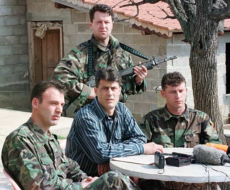 FILE: Hashim Thaci, head of the KLA political directorate, addresses a press conference in a secret location in central Kosovo, 13 March 1999