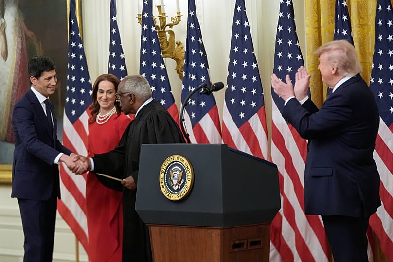 US President Donald Trump applauds Kevin Warsh, after being sworn in as Chairman of the Federal Reserve in the East Room of the White House, 22 May 2026