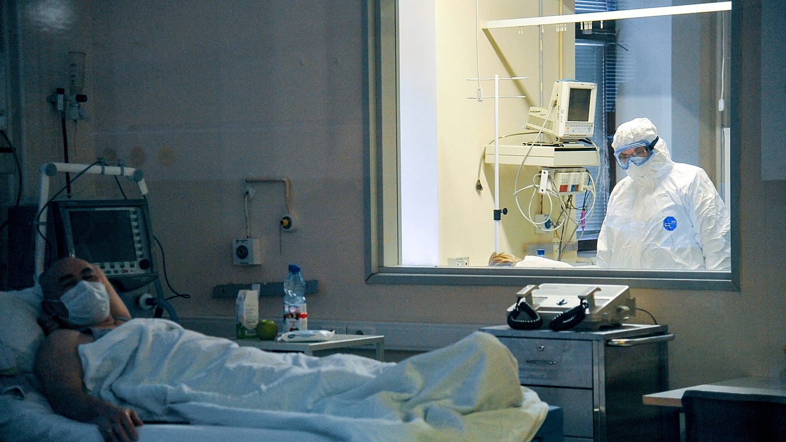 FILE: A doctor observes a patient's condition in a ward at the Moscow Sklifosovsky emergency hospital, 25 March 2020