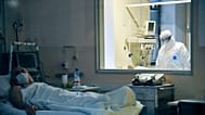 FILE: A doctor observes a patient's condition in a ward at the Moscow Sklifosovsky emergency hospital, 25 March 2020