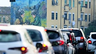 Cars in a traffic jam at a cross roads in Rome, Friday, Nov. 14, 2025