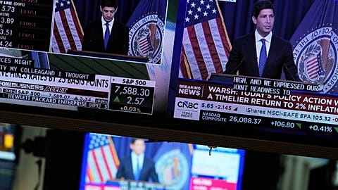 FILE. Screens display the news conference held by Federal Reserve chairman Kevin Warsh on the floor of the New York Stock Exchange, 16 Sept. 2026