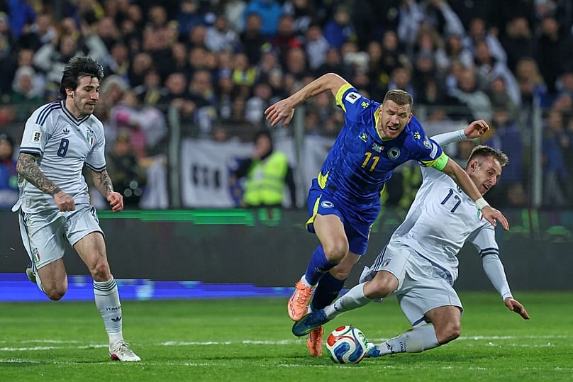 A boszniai Edin Dzeko (középen) és az olasz Davide Frattesi összecsapása a Bosznia és Olaszország közötti világbajnoki selejtező rájátszás döntőjén, Zenicában, Boszniában, 202