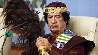 FILE: Libyan leader Moammar Gadhafi fans his face during the Forum of Kings, Princes, Sultans, Sheikhs and Mayors of Africa in Tripoli, 8 September 2010
