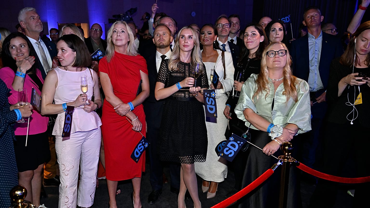 Far-right Sweden Democrats members react to the presentation of the exit poll at the election night watch party, in Stockholm. 13 September 2026.