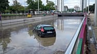 A tunnel flooded by heavy rains, with a car floating inside, on the outskirts of the Spanish city of Valencia