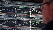 Financial market data is displayed on trading screens.