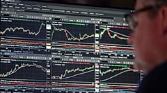 Financial market data is displayed on trading screens.