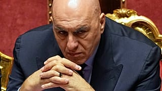 Italy's Defense Minister Guido Crosetto listens as Italy's Prime Minister Giorgia Meloni addresses the Senate regarding the conflict in Iran and the Gulf region, in Rome, Wedn