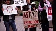 Protesters holding signs reading "Enslaving superintelligence won’t work" and "Stop the AI Race"